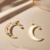 Lunar Bloom earrings with real pressed flowers in resin and 18K gold-plated brass. Bold, handmade floral statement jewelry in a 40mm x 66mm drop design.