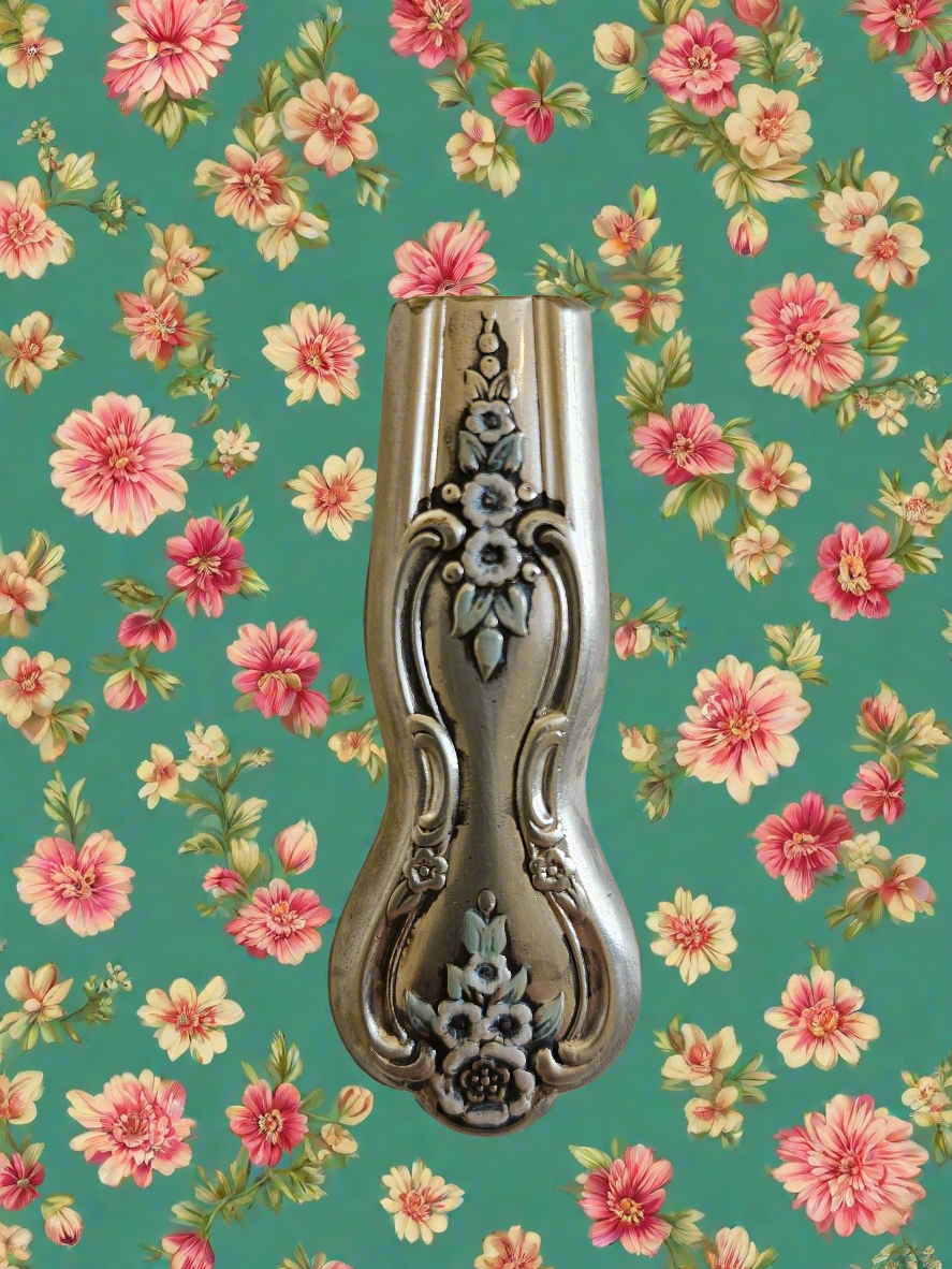 Whimsical bud vases crafted from vintage silverware with magnetic backs—perfect for single blooms and small clippings. Each one is a one-of-a-kind treasure.