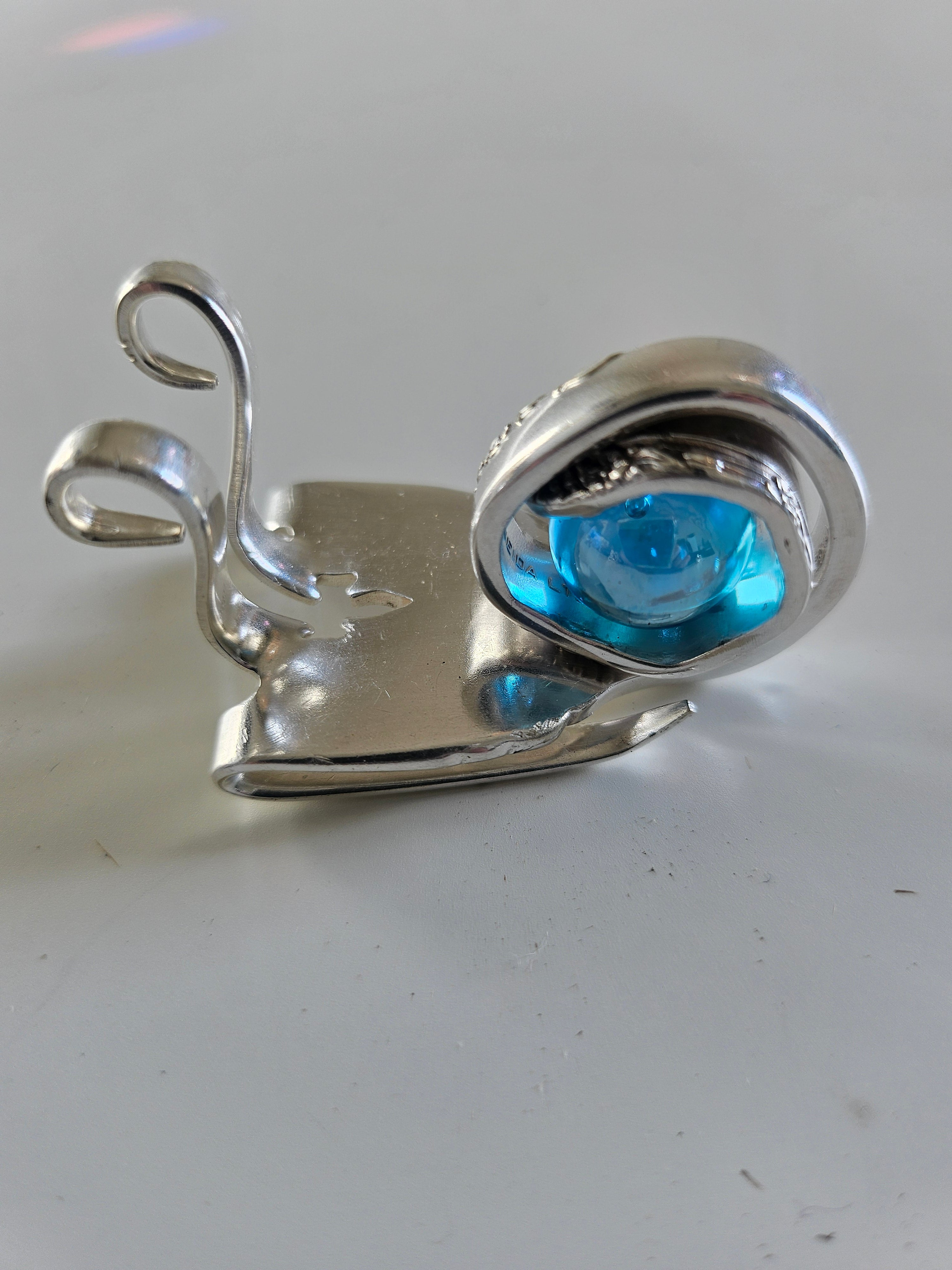 Handcrafted from vintage silverware, these whimsical snails feature shimmering glass orb shells—each a one-of-a-kind symbol of patience and charm.