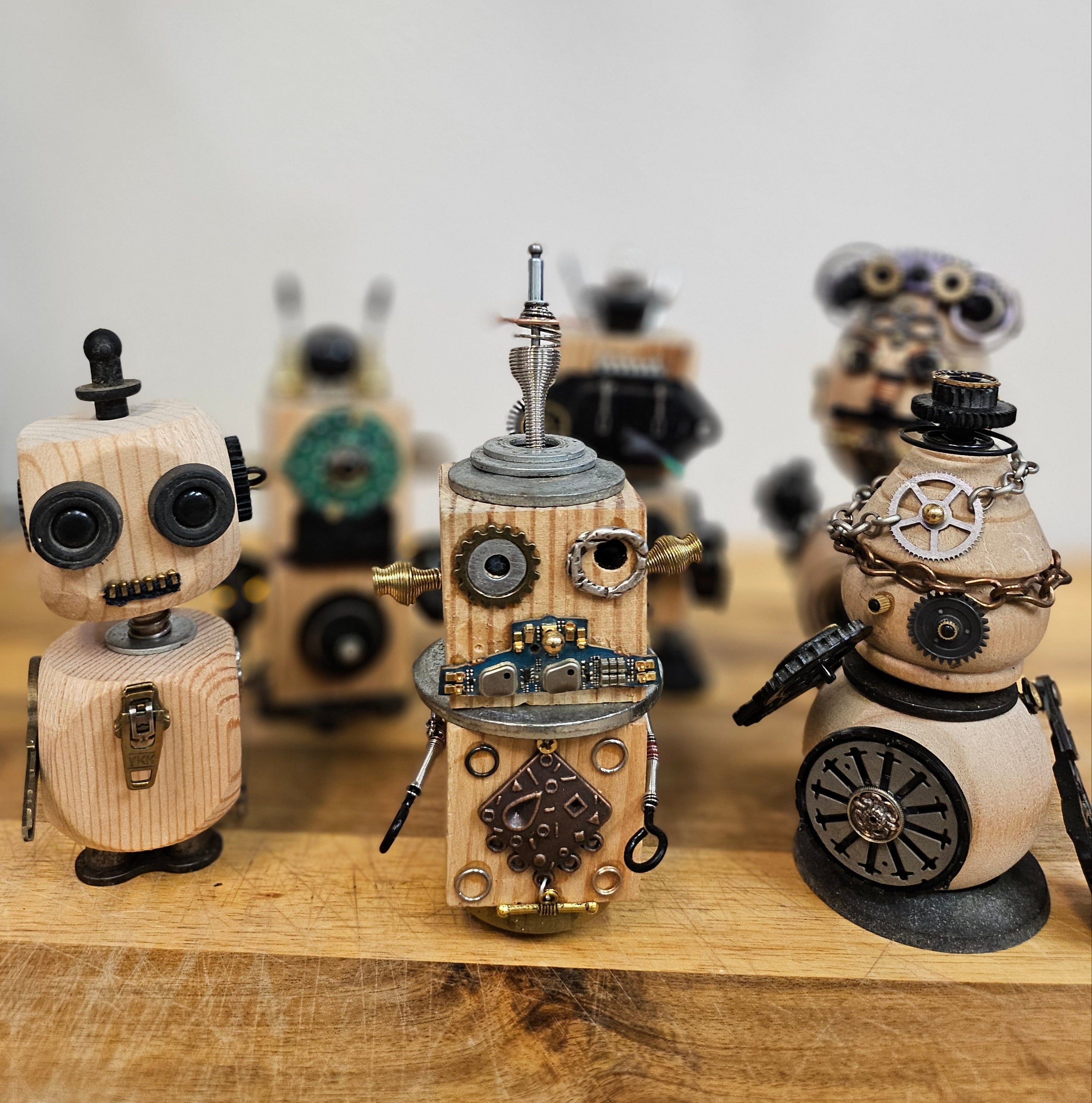 The Handmade Wood Block Steampunk Robot is a unique, decorative figurine crafted from wood with an aged, rustic look. Each robot is one-of-a-kind for display only. Includes a heart-shaped balloon. Available in various sizes, it&