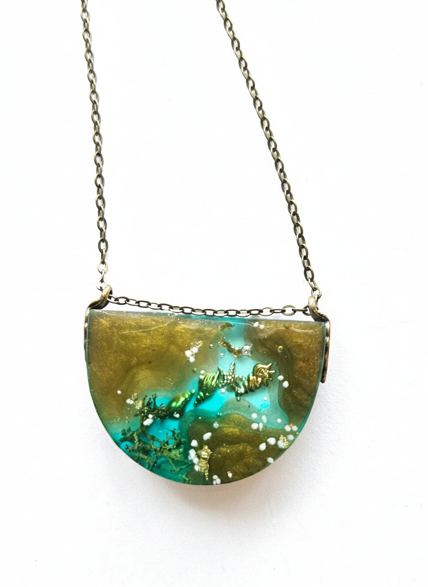 Sea Life Resin Pendant Necklaces by artist KStonely featuring shells, fish, jellyfish, and sea life miniatures in dreamy blue, brown, and gold ocean-inspired resin.