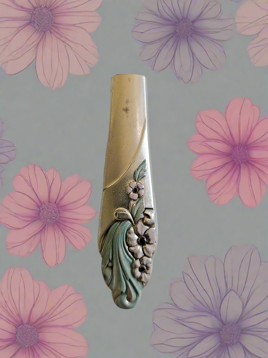 Whimsical bud vases crafted from vintage silverware with magnetic backs—perfect for single blooms and small clippings. Each one is a one-of-a-kind treasure.
