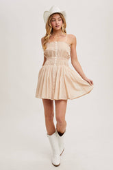 Smocked mini dress with button-down front, adjustable straps & breezy skirt. A flattering, lightweight style perfect for summer days & casual outings.