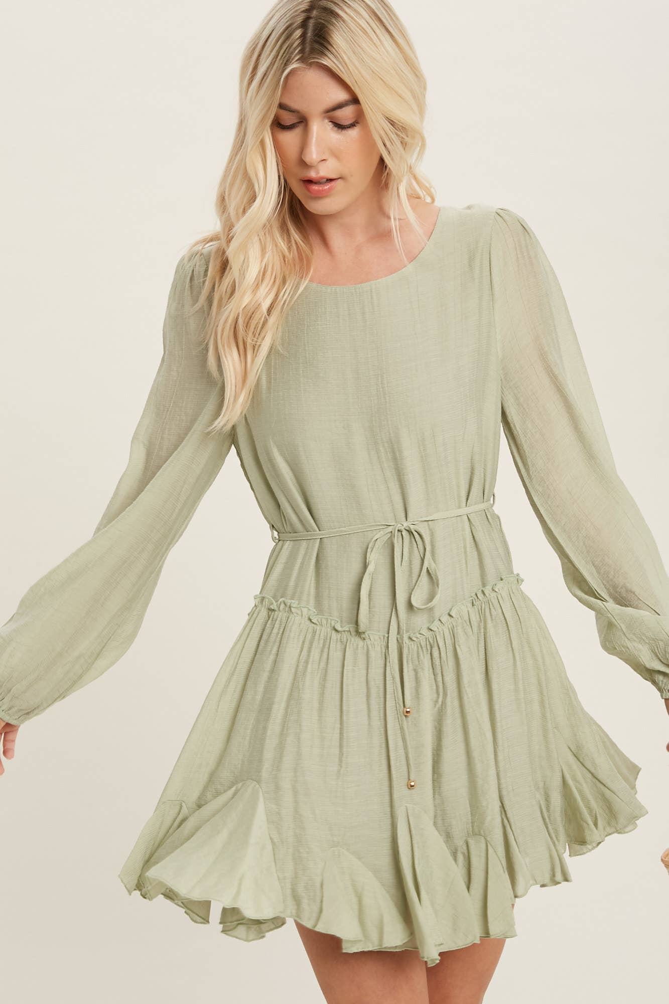 A flirty mini swing dress with balloon sleeves, ruffle trim, and adjustable waist. Lightweight, breathable, and perfect for everyday whimsy.