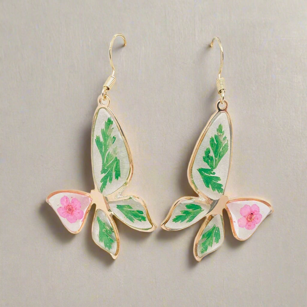 Narcissus & Ferns Butterfly Earrings with real pressed flowers in resin and gold-tone metal. Lightweight, nature-inspired statement jewelry for any occasion.