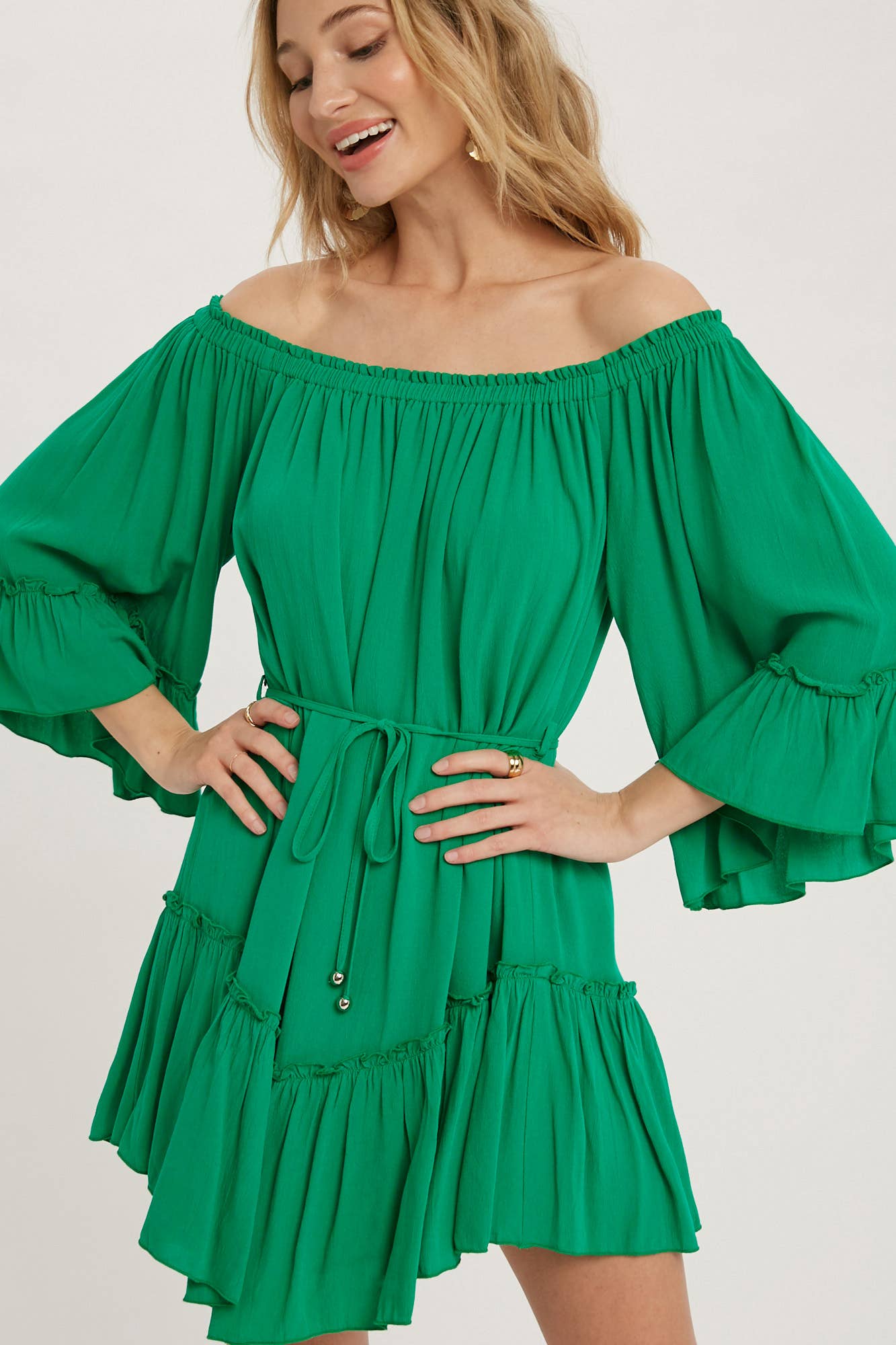 Romantic off-shoulder dress with ruffled sleeves, frilled hem, and a swingy silhouette. Adjustable belt adds shape to this breezy, flounce favorite.