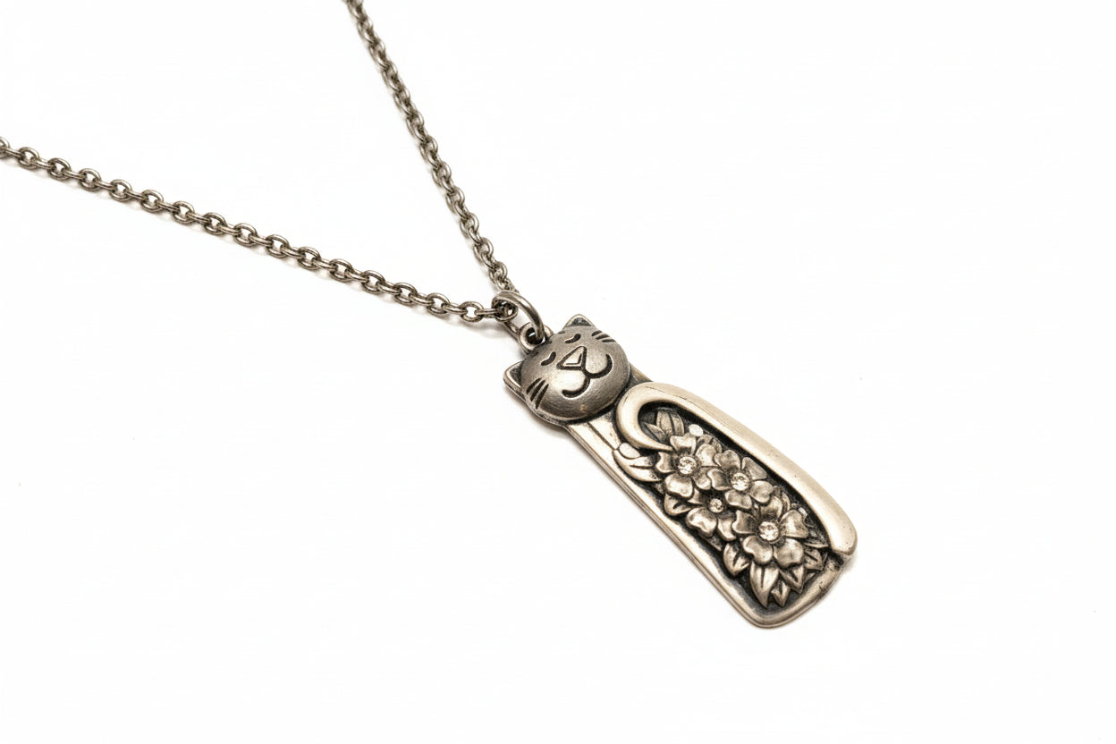 Handmade silver cat pendant necklaces from vintage silverware. Elegant, whimsical, and adjustable on a satin cord. Sustainably crafted and one-of-a-kind.