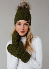 Olive green knit hat with natural faux fur pom. Cozy, stylish, and versatile—crafted from 100% acrylic for warmth and everyday boho-chic winter vibes.