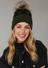 Olive skull pattern knit hat with natural faux fur pom. Fleece lined for cozy warmth and style. 100% acrylic and pairs perfectly with matching mittens.