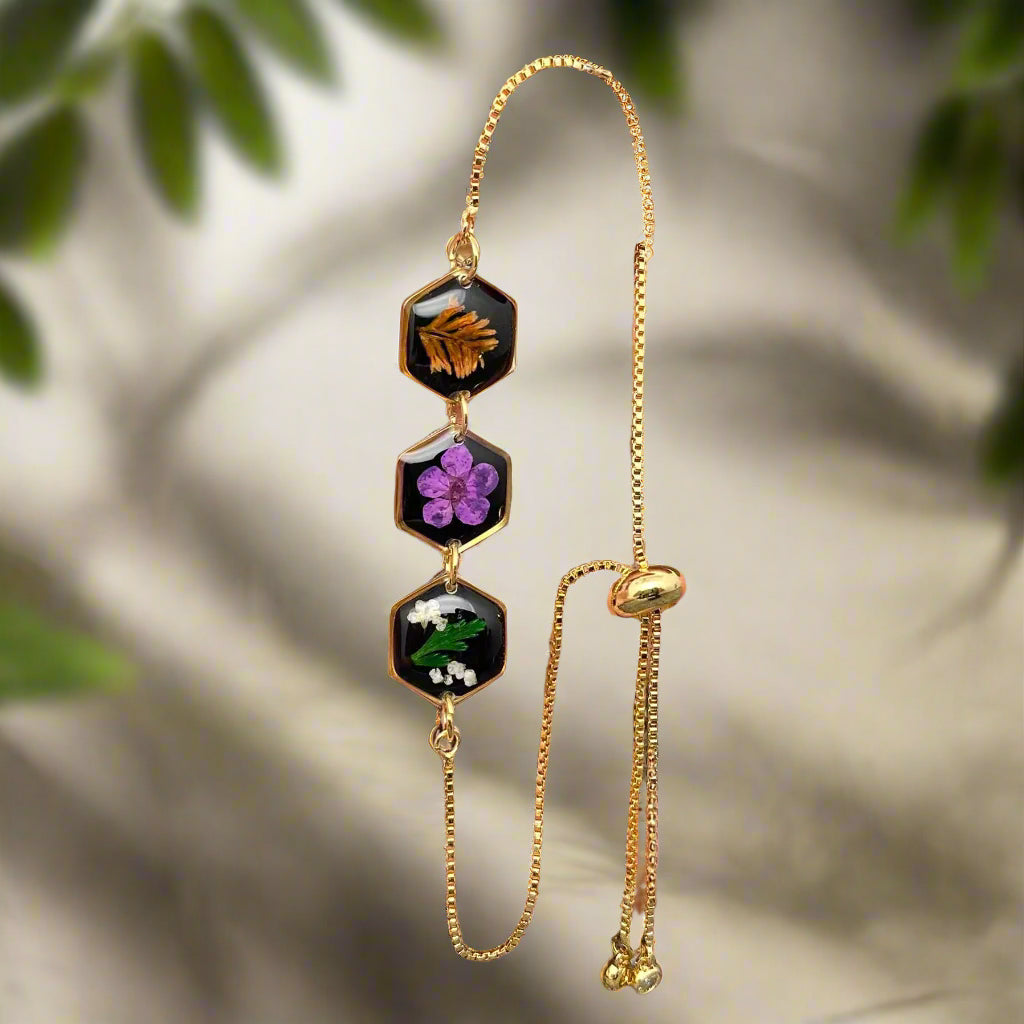 Wildflower Whisper Bracelet with real pressed flowers in resin and adjustable stainless-steel chain. Unique, hypoallergenic, and perfect for everyday nature lovers.