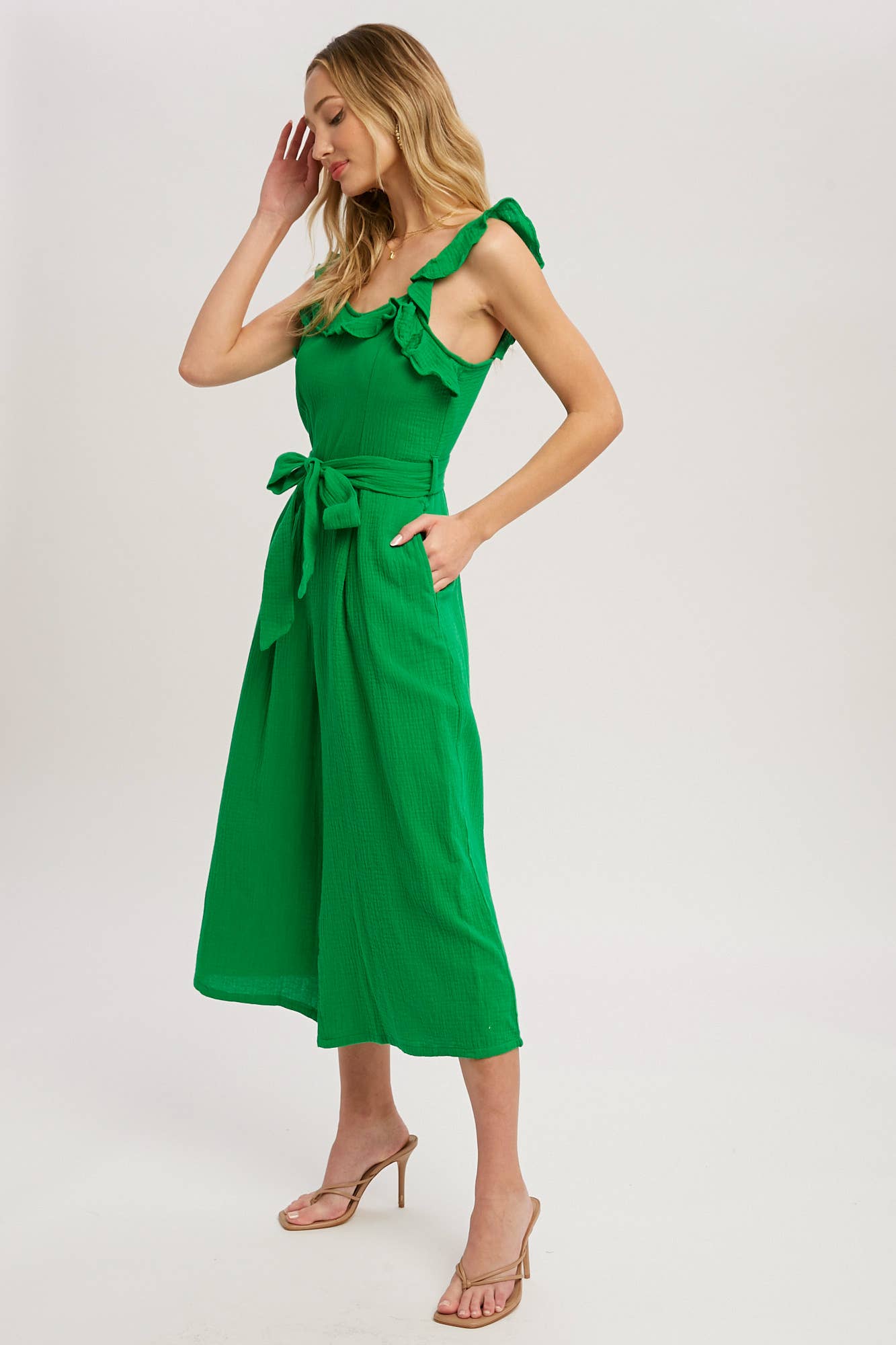 Chic textured cotton jumpsuit with frill trim, wide-leg fit, side pockets, self-tie waist, and back zipper. A relaxed, flattering one-piece for any season.