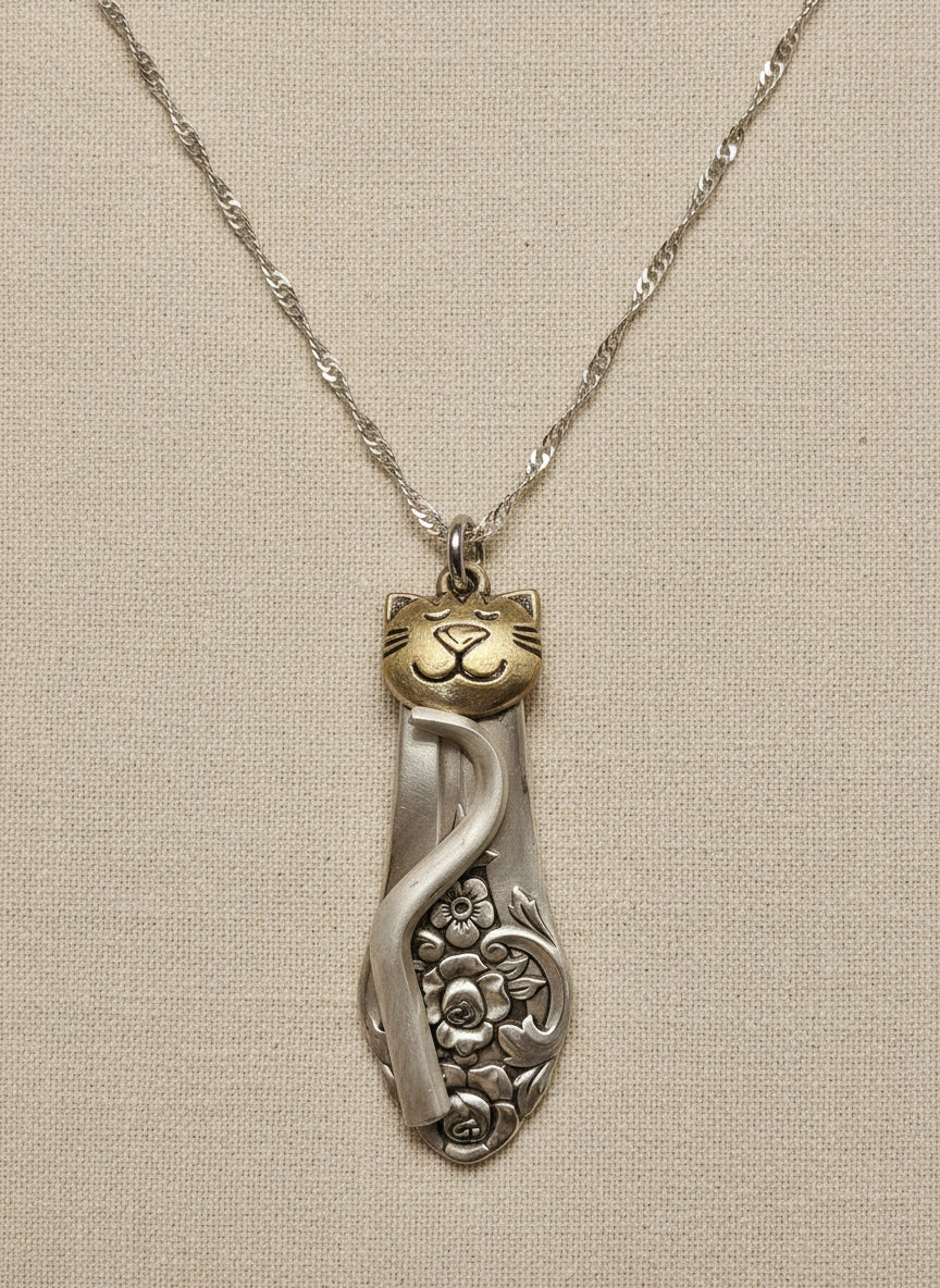 Handmade silver cat pendant necklaces from vintage silverware. Elegant, whimsical, and adjustable on a satin cord. Sustainably crafted and one-of-a-kind.