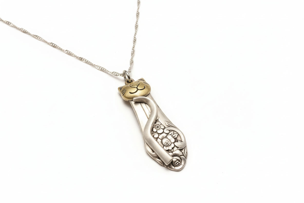 Handmade silver cat pendant necklaces from vintage silverware. Elegant, whimsical, and adjustable on a satin cord. Sustainably crafted and one-of-a-kind.