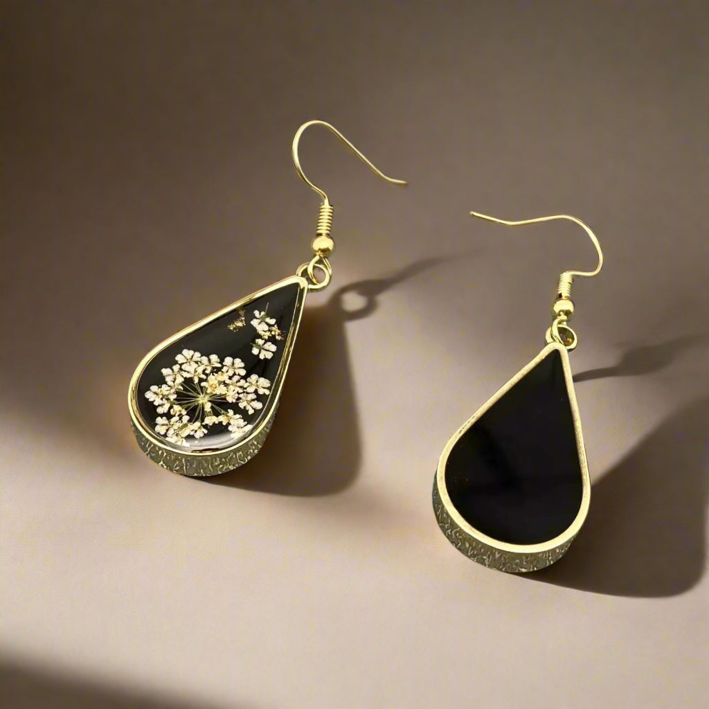 Dark Botanica earrings showcase real Queen Anne’s Lace in black resin teardrop earrings with gold-plated frames—bold, elegant earrings that are naturally one-of-a-kind.