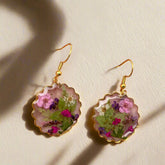 Handmade drop earrings with real pressed flowers in resin and stainless steel hooks. Each 26x43mm pair is unique, lightweight, and nature inspired.