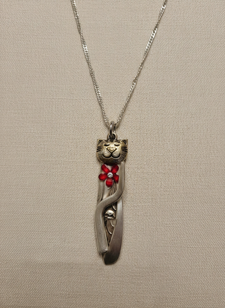 Handmade silver cat pendant necklaces from vintage silverware. Elegant, whimsical, and adjustable on a satin cord. Sustainably crafted and one-of-a-kind.