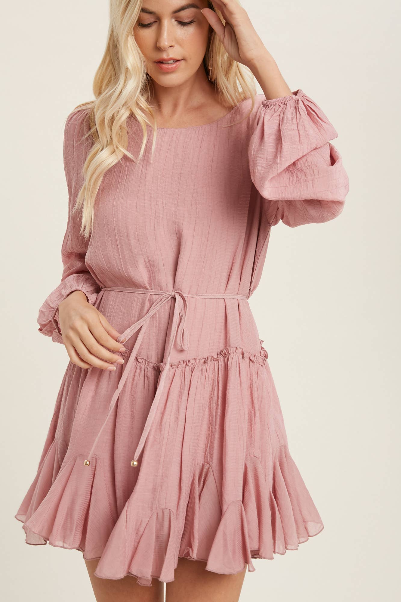 A flirty mini swing dress with balloon sleeves, ruffle trim, and adjustable waist. Lightweight, breathable, and perfect for everyday whimsy.