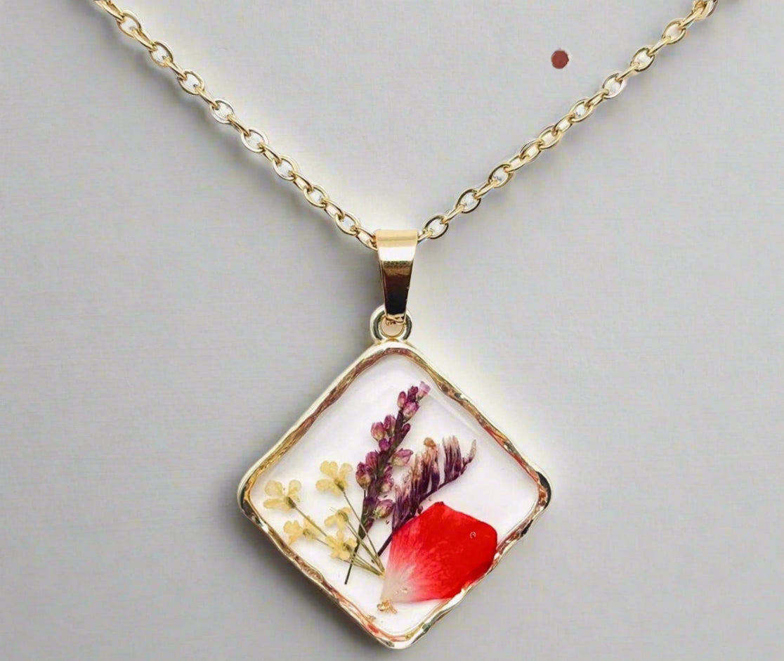 Handcrafted square pendant necklace with real pressed dried flowers in clear resin. Unique botanical jewelry with stainless steel chain and copper frame.