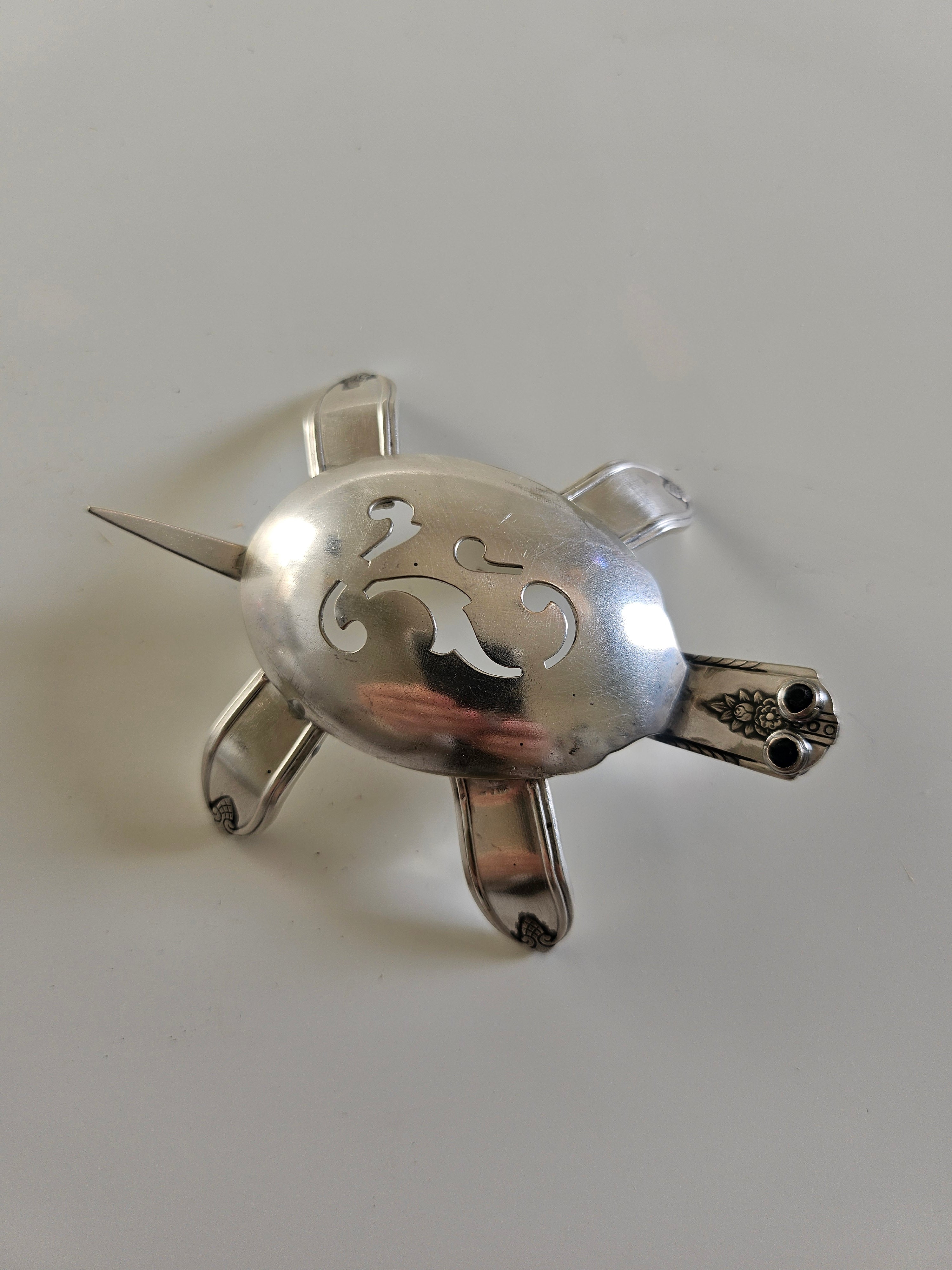 Handcrafted from vintage silverware, these salvaged scorpion and turtle sculptures bring charm, symbolism, and eco-friendly artistry to any space
