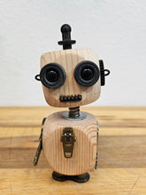 The Handmade Wood Block Steampunk Robot is a unique, decorative figurine crafted from wood with an aged, rustic look. Each robot is one-of-a-kind for display only. Includes a heart-shaped balloon. Available in various sizes, it&