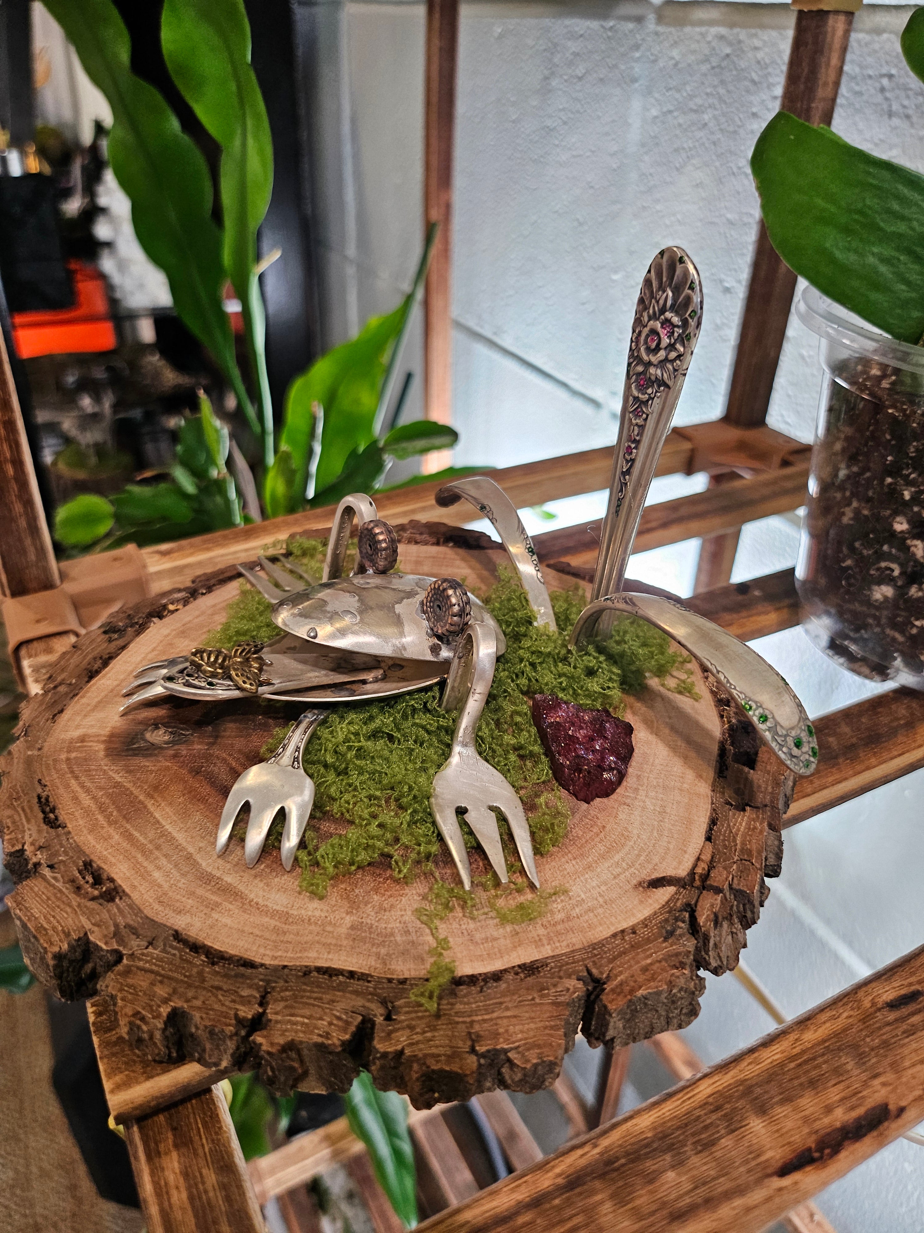 Handcrafted frog sculpture from vintage silverware, set on walnut wood with moss and crystals. A whimsical, one-of-a-kind piece for home or garden décor.