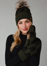 Olive skull pattern knit hat with natural faux fur pom. Fleece lined for cozy warmth and style. 100% acrylic and pairs perfectly with matching mittens.