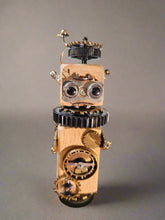 The Handmade Wood Block Steampunk Robot is a unique, decorative figurine crafted from wood with an aged, rustic look. Each robot is one-of-a-kind for display only. Includes a heart-shaped balloon. Available in various sizes, it&