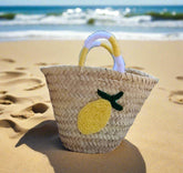 Cheerful straw tote with crocheted lemon patch and colorful handles. Lightweight, eco-friendly, and perfect for markets, beach days, or sunny adventures.