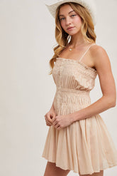 Smocked mini dress with button-down front, adjustable straps & breezy skirt. A flattering, lightweight style perfect for summer days & casual outings.