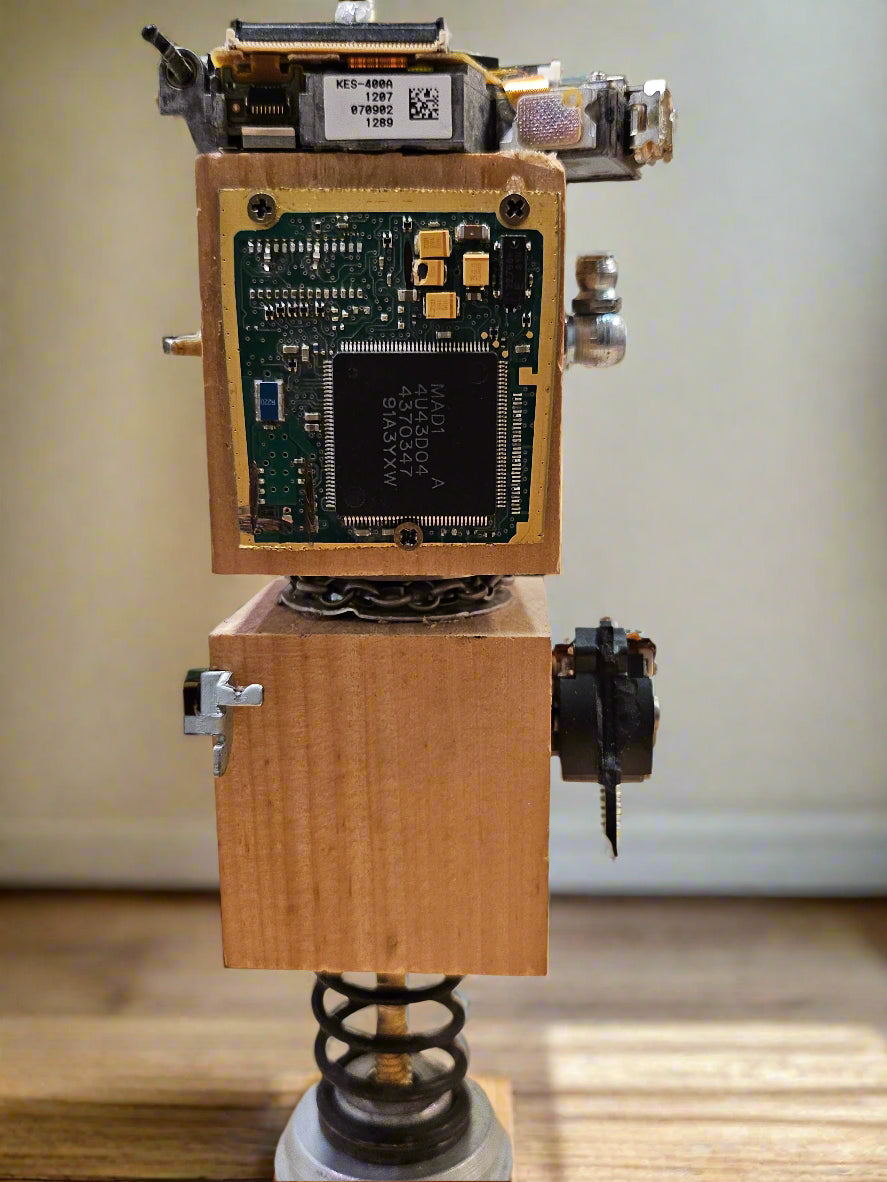 The Handmade Wood Block Steampunk Robot is a unique, decorative figurine crafted from wood with an aged, rustic look. Each robot is one-of-a-kind for display only. Includes a heart-shaped balloon. Available in various sizes, it&