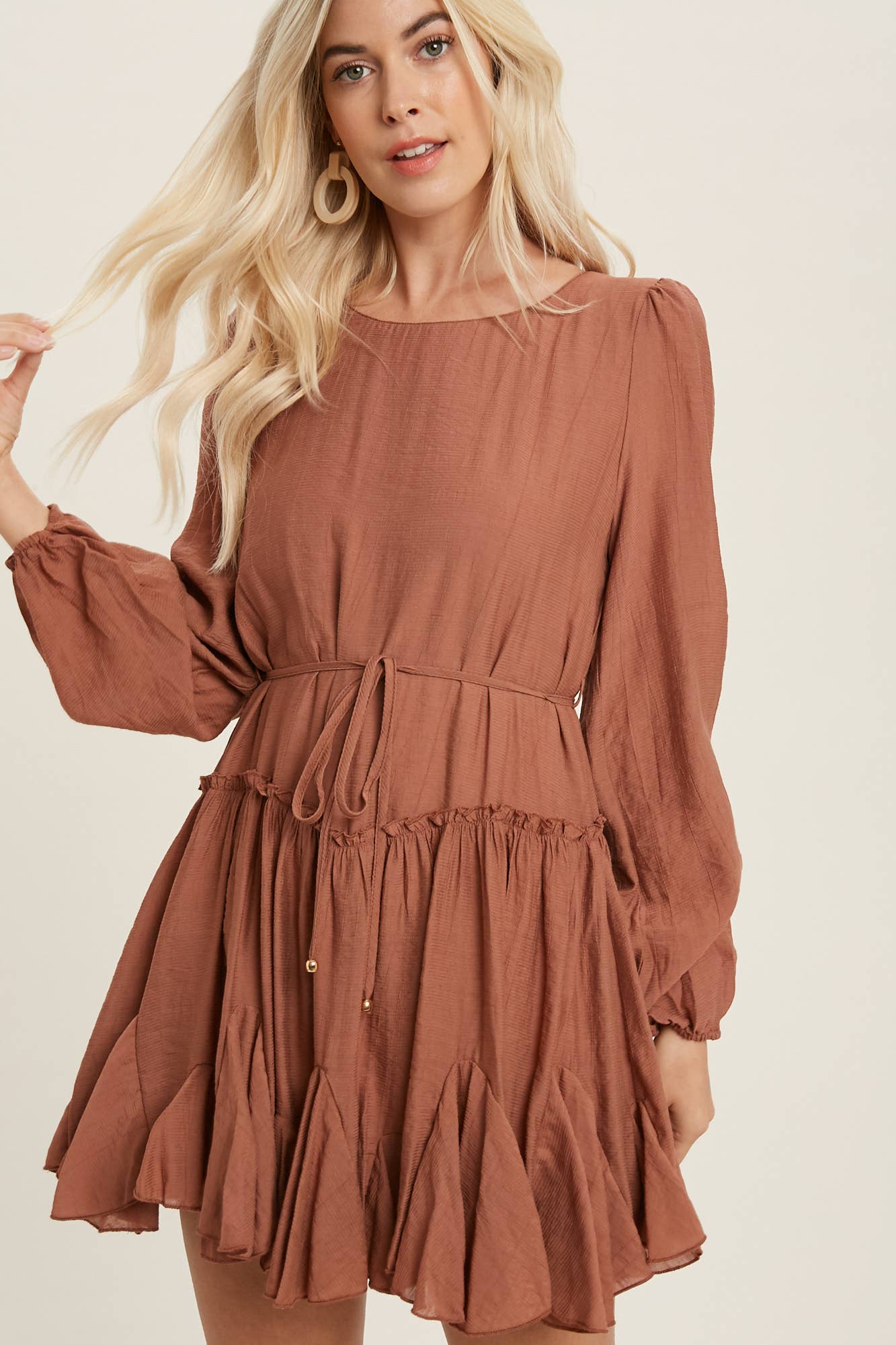 A flirty mini swing dress with balloon sleeves, ruffle trim, and adjustable waist. Lightweight, breathable, and perfect for everyday whimsy.