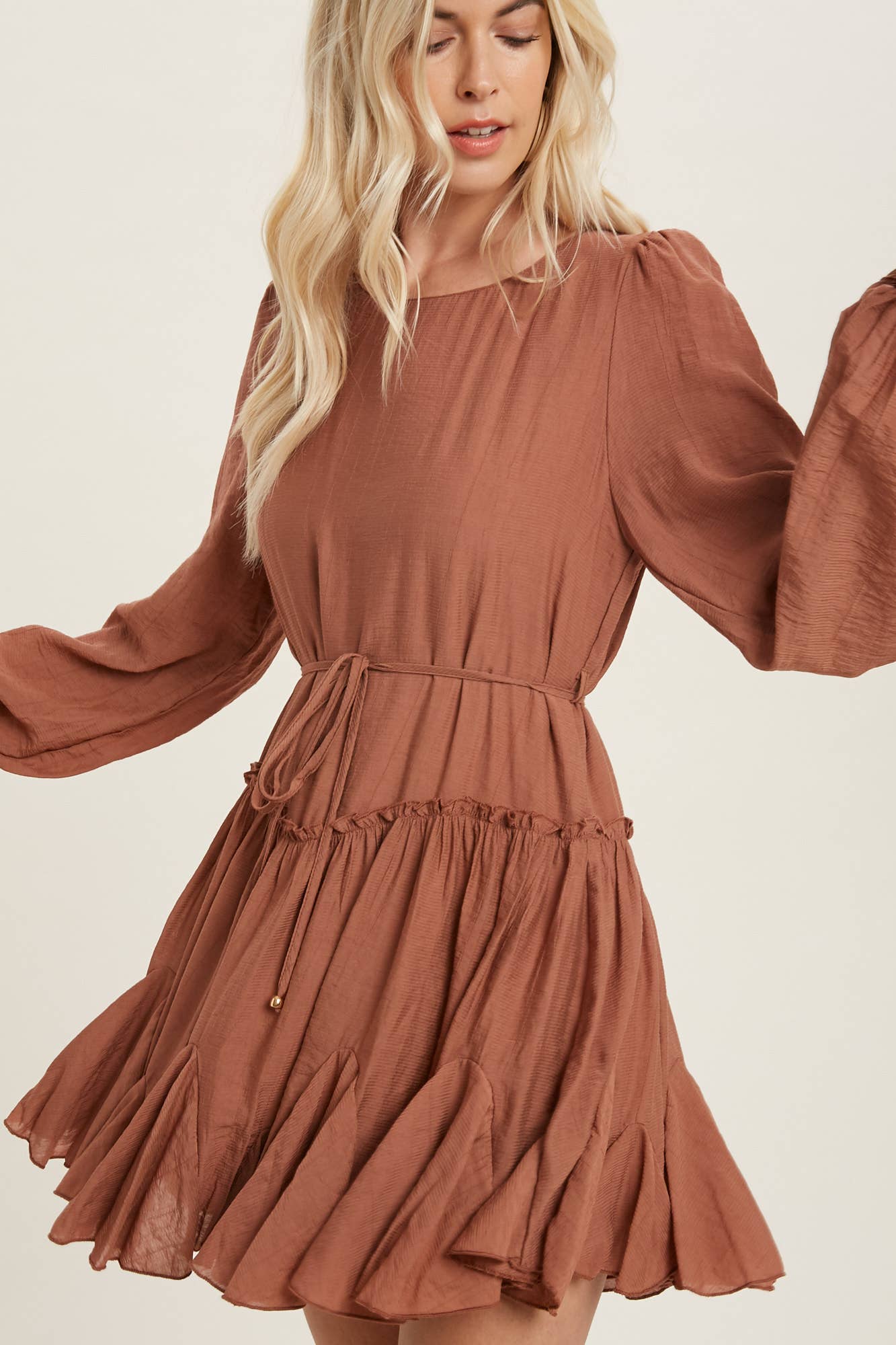 A flirty mini swing dress with balloon sleeves, ruffle trim, and adjustable waist. Lightweight, breathable, and perfect for everyday whimsy.