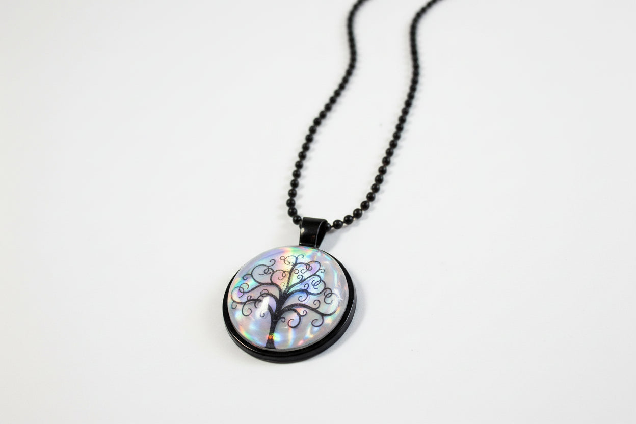Handcrafted nature scene necklaces with real botanicals in iridescent and clear resin. Unique, wearable landscapes on chain or satin cord.