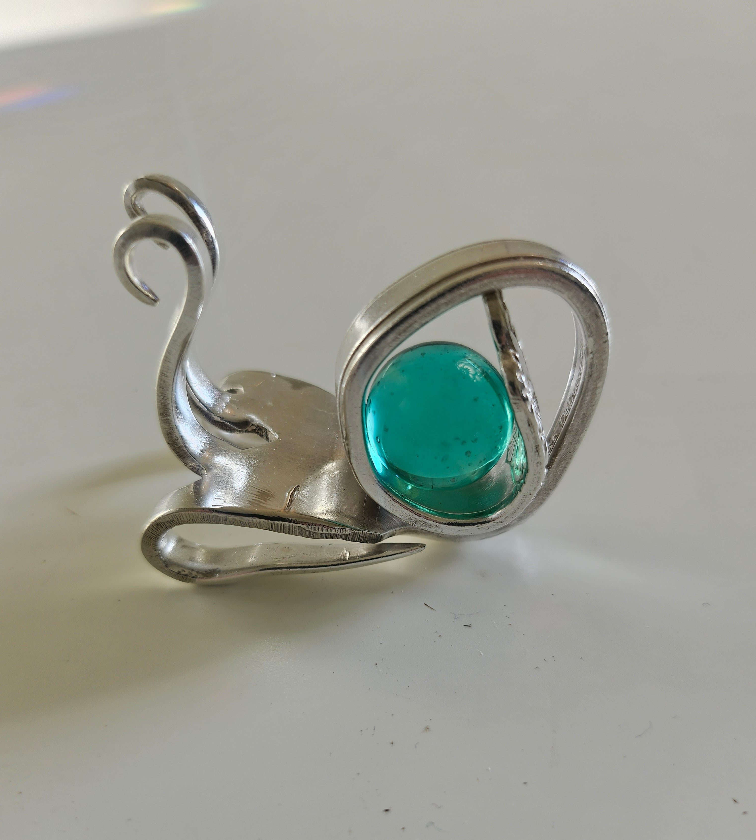 Handcrafted from vintage silverware, these whimsical snails feature shimmering glass orb shells—each a one-of-a-kind symbol of patience and charm.