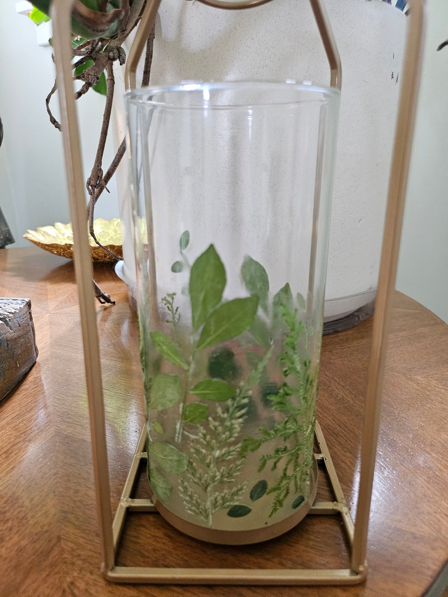 Verdant Canopy Gold Lantern features real pressed ferns and greenery in a gold frame, bringing forest charm and calming light to any indoor or outdoor space.