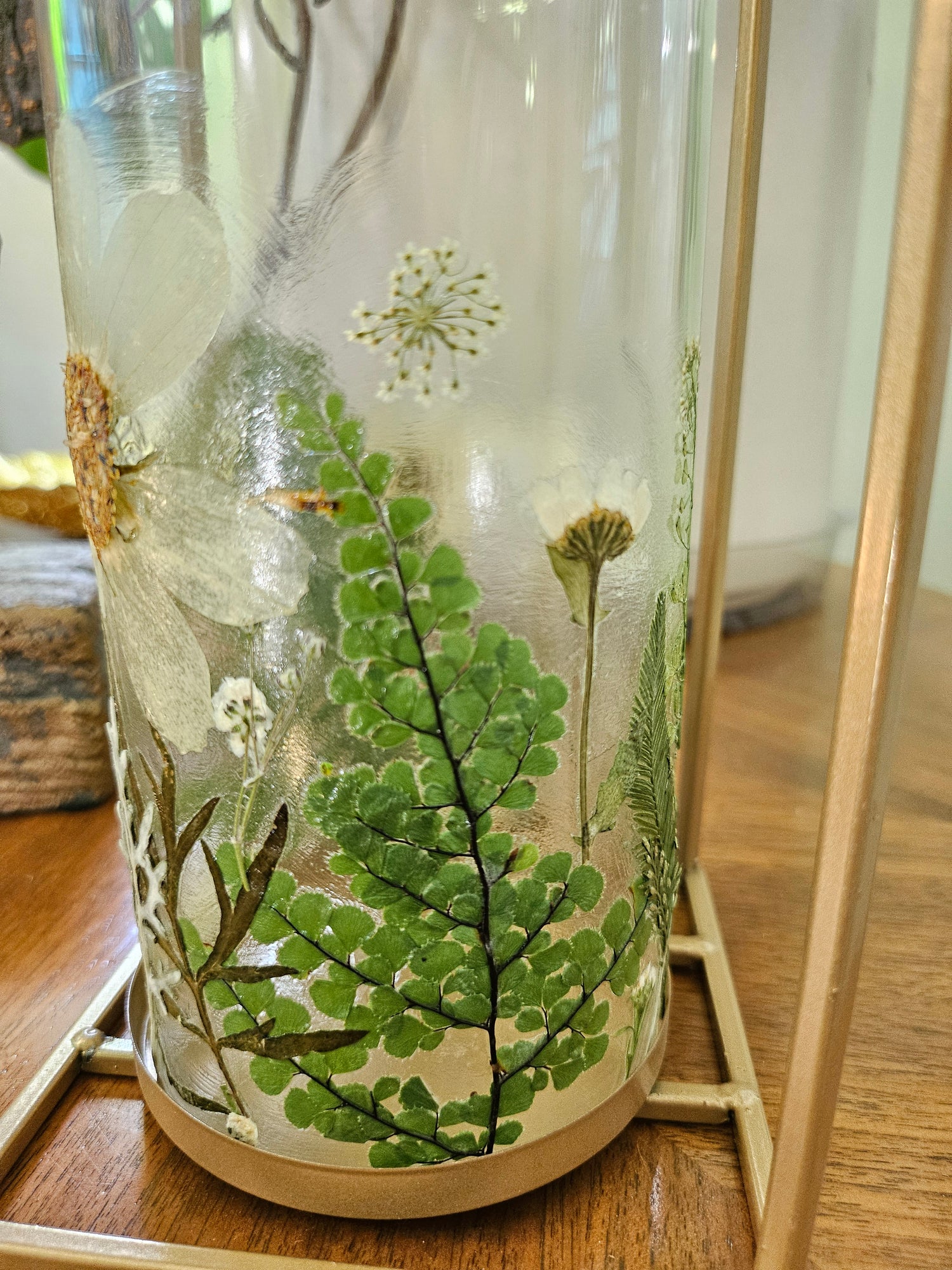 Verdant Canopy Gold Lantern features real pressed ferns and greenery in a gold frame, bringing forest charm and calming light to any indoor or outdoor space.