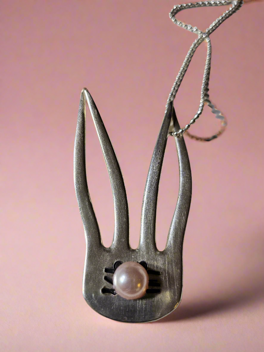 The Salvaged Silver Bunny Pendant is a handcrafted, one-of-a-kind piece made from recycled vintage silverware. Designed by artisan KStonely, it blends whimsical Easter charm with sustainable craftsmanship. Lightweight and unique, it’s perfect for everyday wear or special occasions. A timeless, upcycled treasure that celebrates history and artistry.