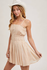 Smocked mini dress with button-down front, adjustable straps & breezy skirt. A flattering, lightweight style perfect for summer days & casual outings.