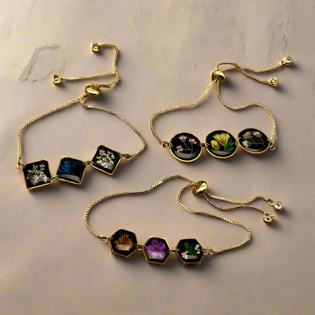 Wildflower Whisper Bracelet with real pressed flowers in resin and adjustable stainless-steel chain. Unique, hypoallergenic, and perfect for everyday nature lovers.