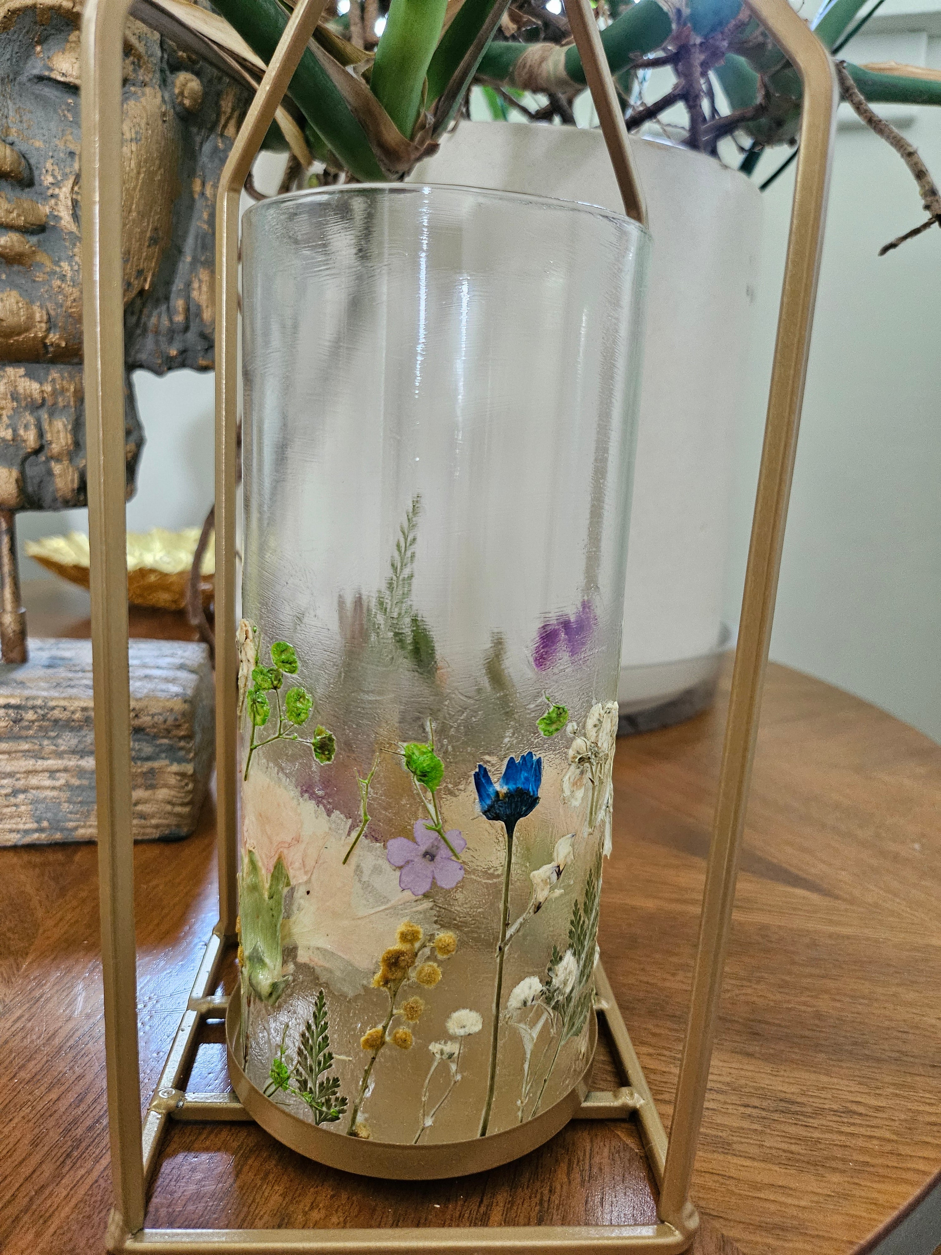 Wildflower candle lantern with real pressed flowers and gold lantern frame. A dreamy botanical accent for garden weddings, decor, and cozy, cottagecore spaces.