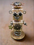 The Handmade Wood Block Steampunk Robot is a unique, decorative figurine crafted from wood with an aged, rustic look. Each robot is one-of-a-kind for display only. Includes a heart-shaped balloon. Available in various sizes, it&