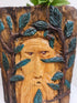 This Hand-Carved & Painted Wood Spirit Planter in solid walnut features intricate details and black-painted accents. 100% handmade, each piece is unique and perfect for home decor or garden. The natural walnut grain and artisanal craftsmanship add rustic charm, making it a standout decorative piece for any space.