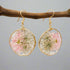 Blushing Bloom earrings feature real pink delphinium and Queen Anne’s Lace in clear resin with copper frames—lightweight, romantic, and naturally one-of-a-kind.