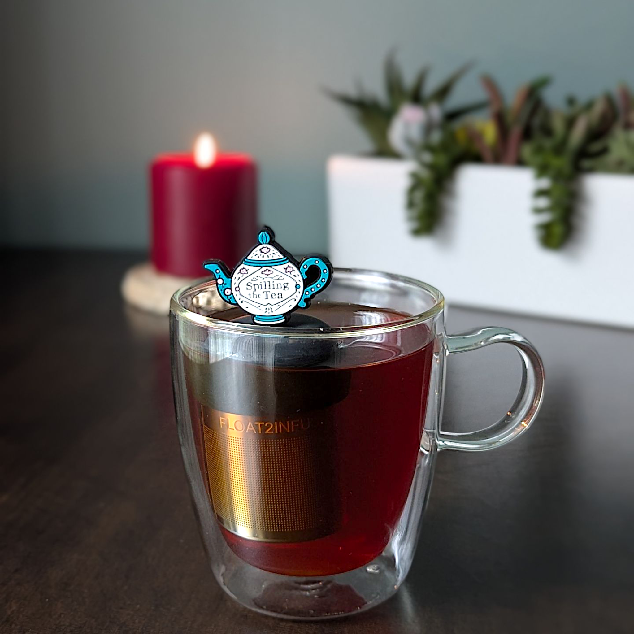 Spilling the Tea floating tea infuser with stainless-steel mesh and silicone top. Cute, reusable, dishwasher-safe steeper for loose-leaf tea lovers.