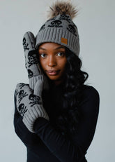Gray skull patterned knit mittens with cozy fleece lining. Made from 100% acrylic for warmth and comfort. A bold, stylish essential for cold winter days.
