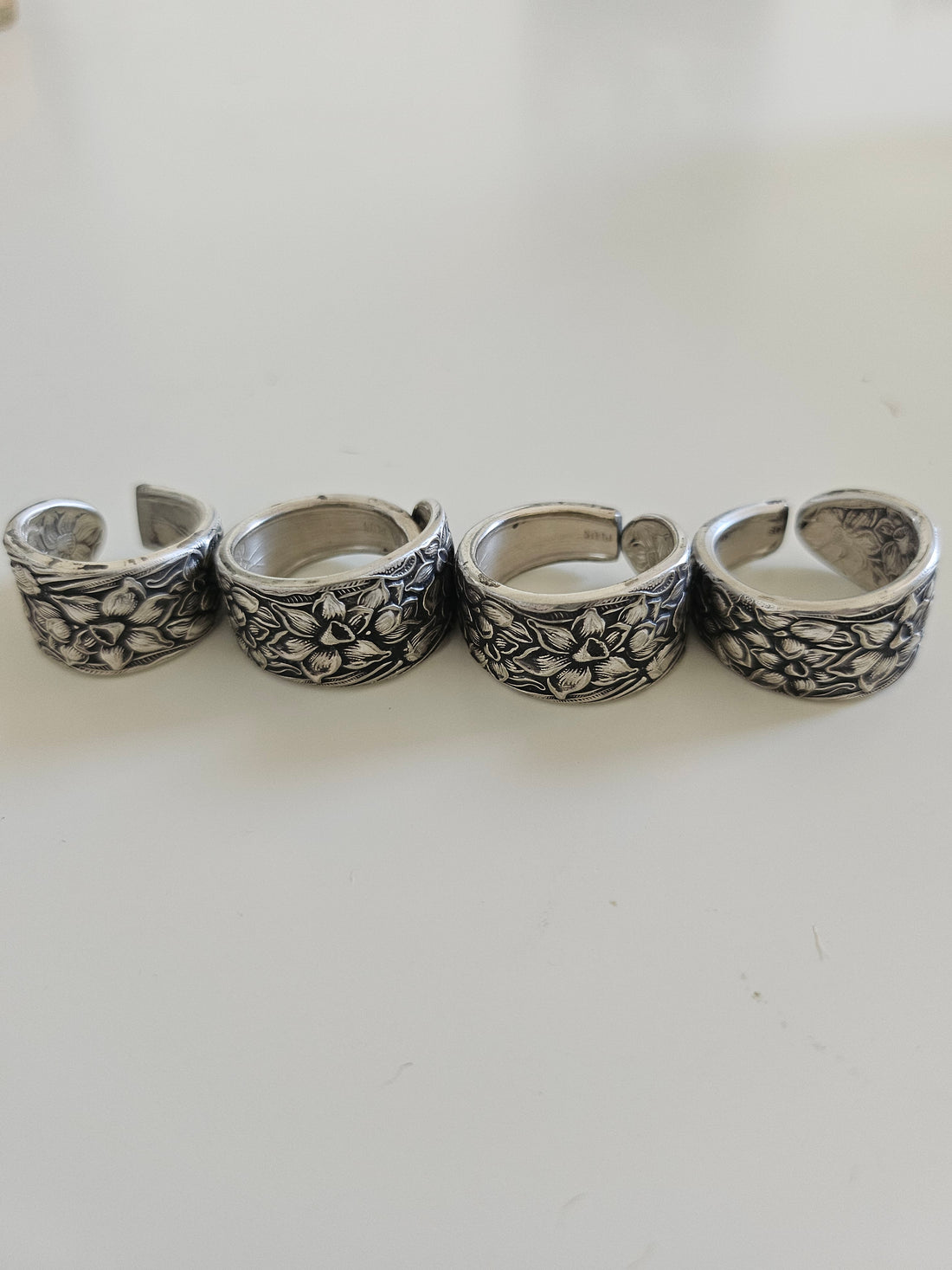 Handcrafted from 1935 Narcissus silverware, this adjustable floral ring by National Silver Co. brings vintage elegance and timeless charm to any outfit.