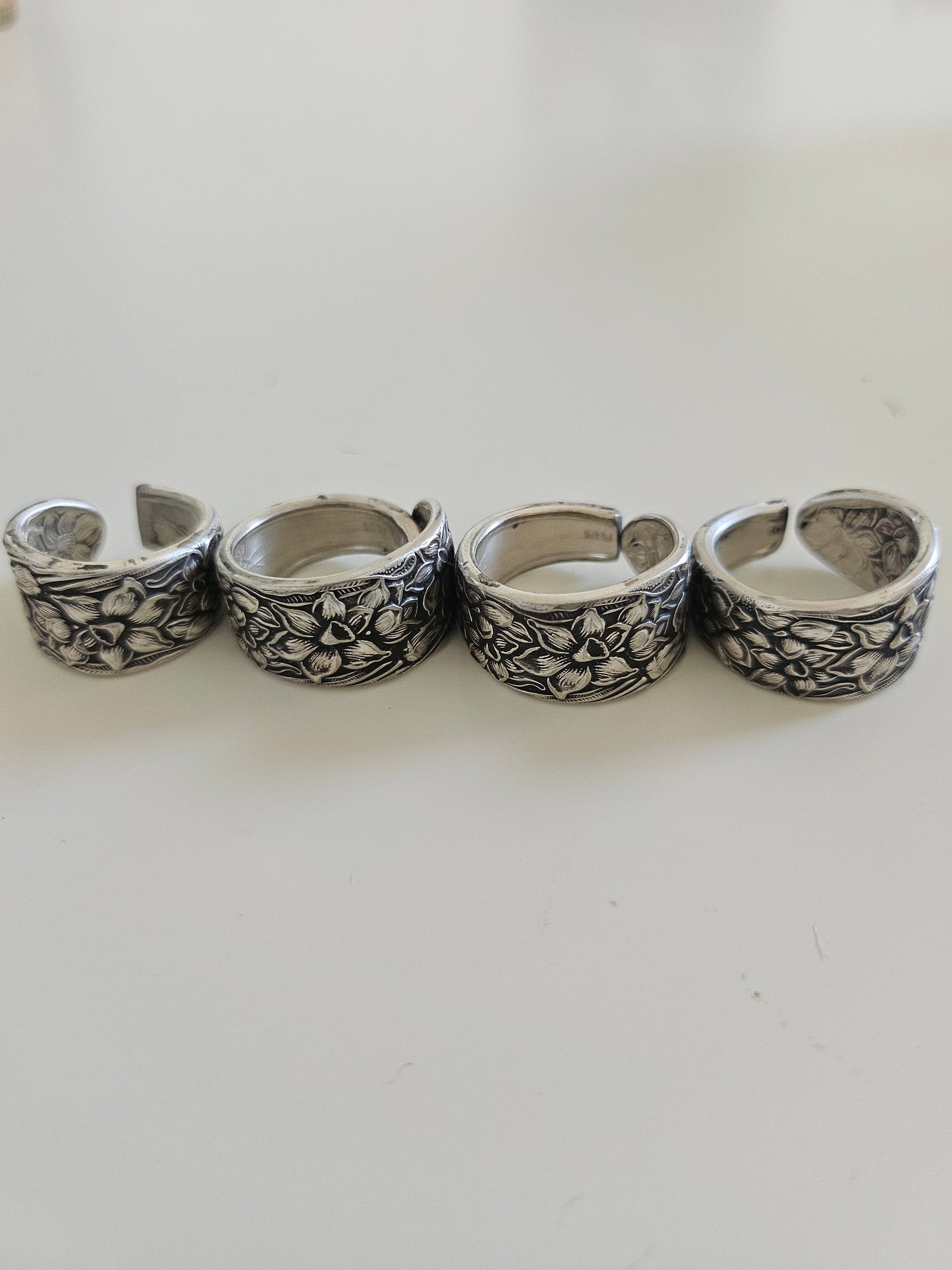 Handcrafted from 1935 Narcissus silverware, this adjustable floral ring by National Silver Co. brings vintage elegance and timeless charm to any outfit.