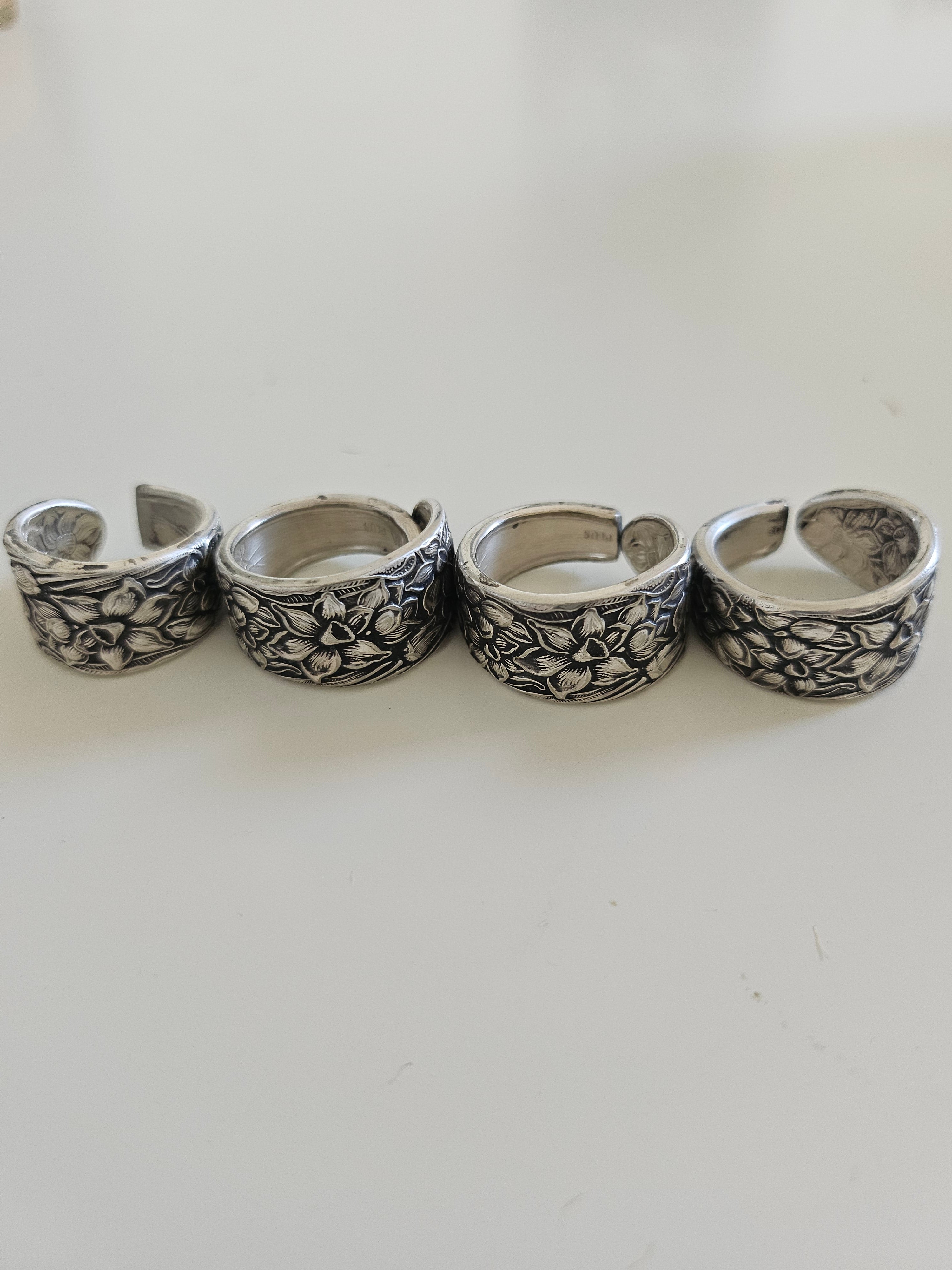 Handcrafted from 1935 Narcissus silverware, this adjustable floral ring by National Silver Co. brings vintage elegance and timeless charm to any outfit.