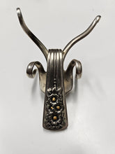 The Lucky Fork Cricket is a handcrafted sculpture made from repurposed vintage silverware, blending artistry with charm. Inspired by crickets—symbols of luck and prosperity—each piece is unique, adorned with jewels and aged patina. A perfect collectible or gift, this whimsical creation brings history, elegance, and positive energy to any space. 