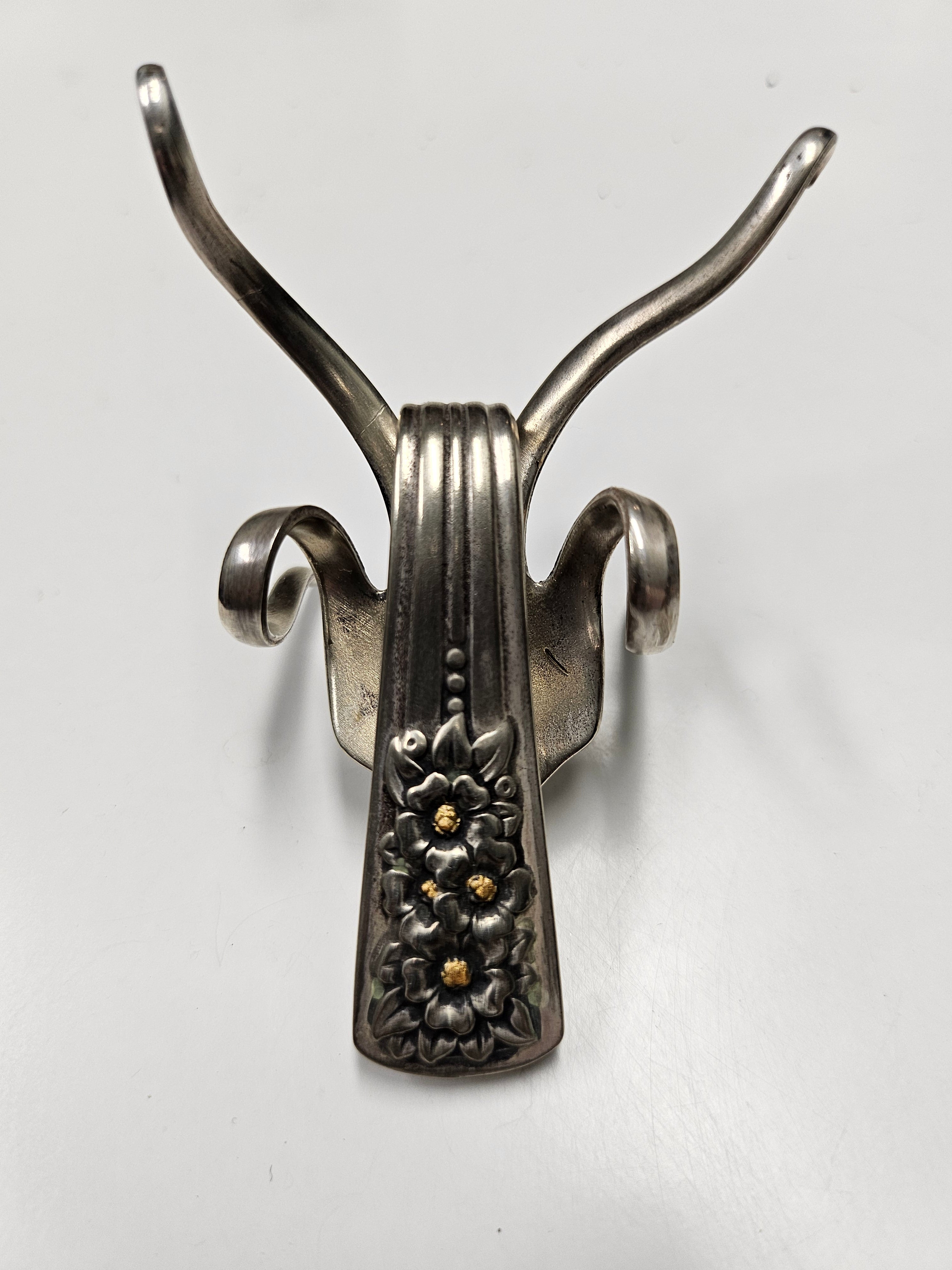 The Lucky Fork Cricket is a handcrafted sculpture made from repurposed vintage silverware, blending artistry with charm. Inspired by crickets—symbols of luck and prosperity—each piece is unique, adorned with jewels and aged patina. A perfect collectible or gift, this whimsical creation brings history, elegance, and positive energy to any space. 